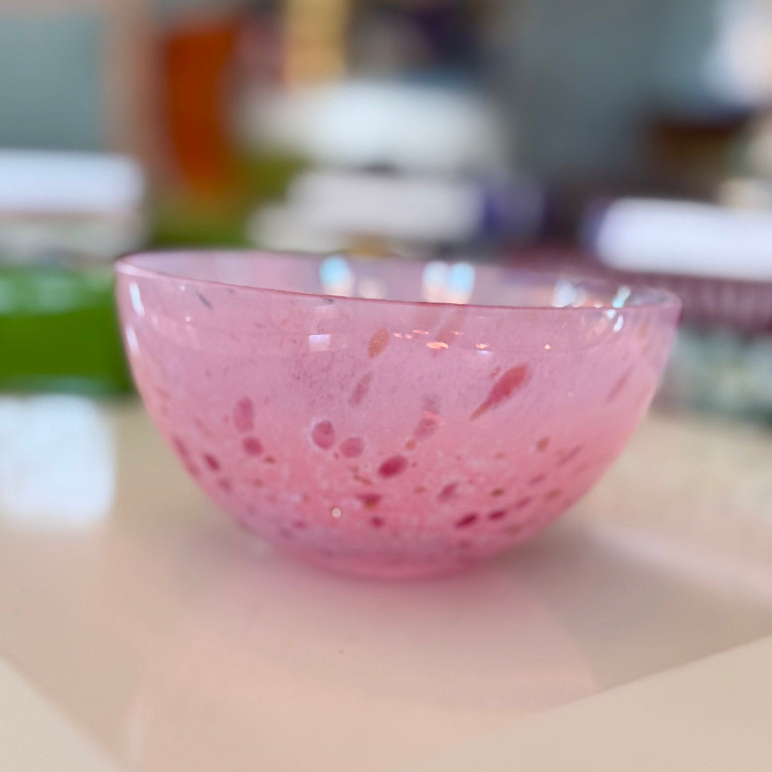 Pink glass bowl on a blurred background