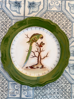 Decorative plate with a bird design on a patterned tile background