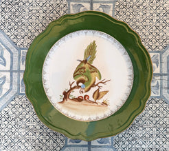 Decorative plate with a green rim on a patterned tile background
