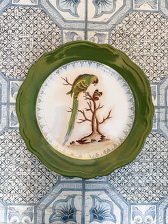 Decorative plate with a bird design on a patterned tile background
